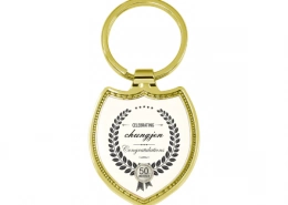 The Front Side Of Shield Shaped Keychain With Embossed Border