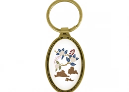 The Front Side Of Vertically Oriented Oval Keychain With Embossed Border